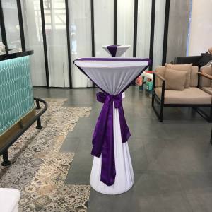 Cocktail table with white cover and purple ribbon