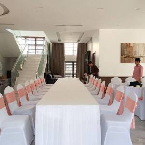Long table with white cover and rose gold ribbon