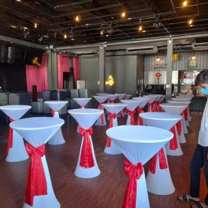 Cocktail table with red ribbon for rent
