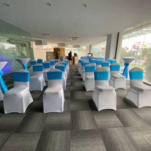 Banquet chair with white cover and light blue ribbon
